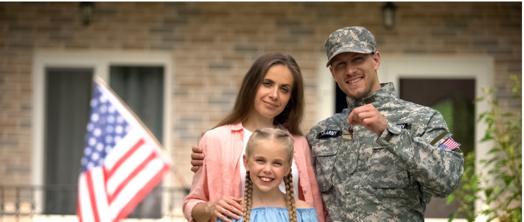 A woman, daughter and husband who is a soldier standing in front of their home holding keys