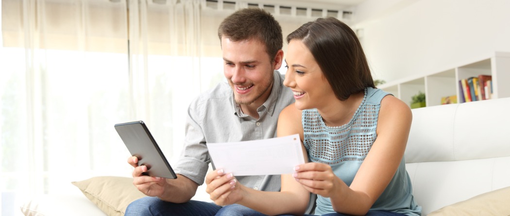  Happy couple looking at online banking