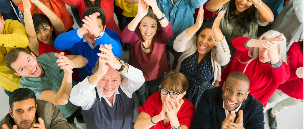 a group of diverse people clapping their hands