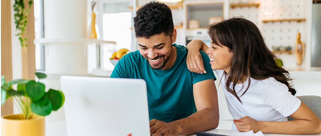 African American Couple looking at their online benefits for their checking account. 