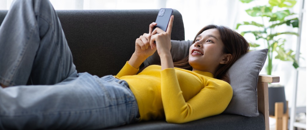 Woman using phone for online banking at  home