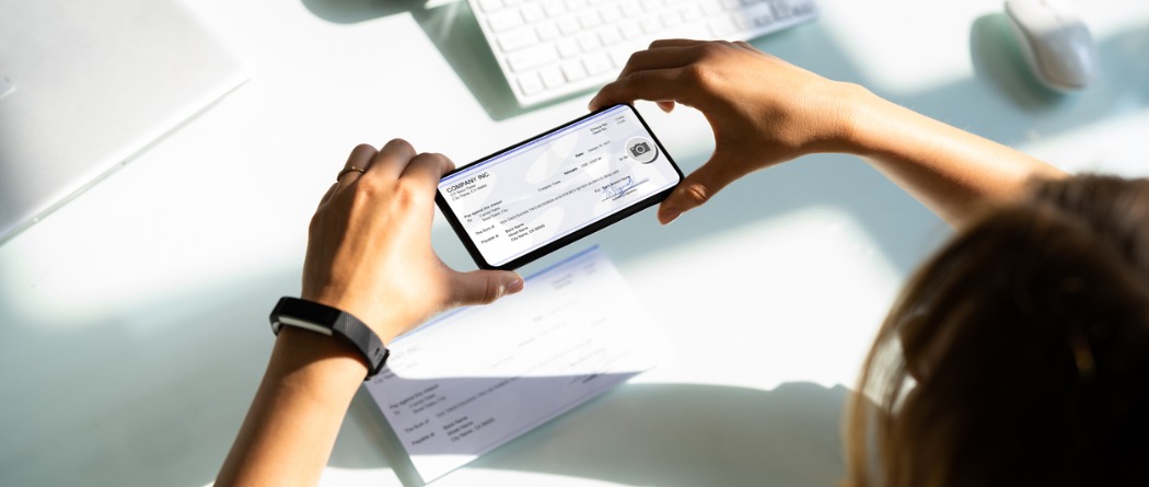 A person taking a picture of a check for deposit using their phone