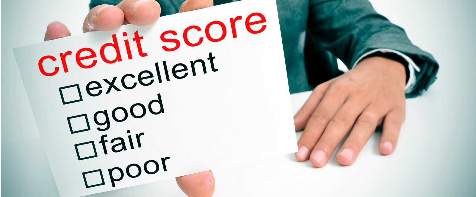 man holding card labeled credit score