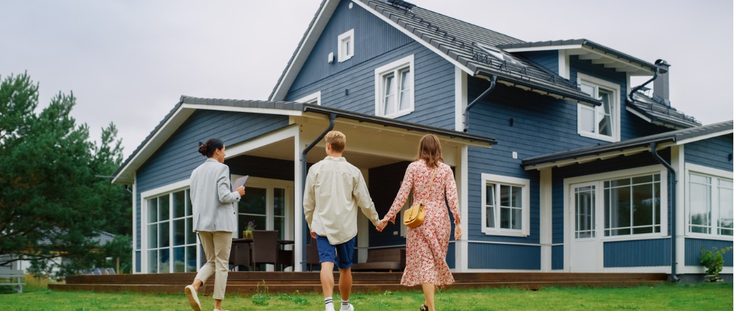 Young couple walking up to a house for sale