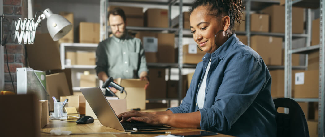 Woman in a shipping center using a laptop