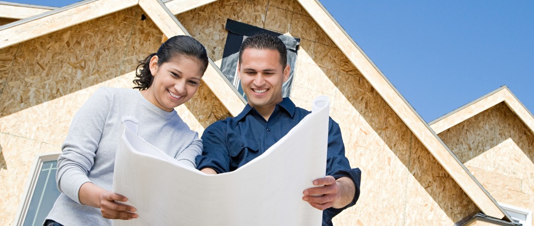 couple looking at plans to build a house