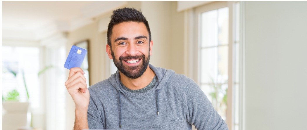 handsome man holding credit card