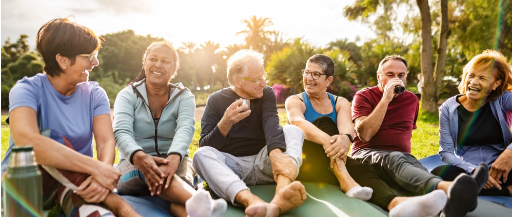 Happy multiracial senior friends relaxing and having a conversation.